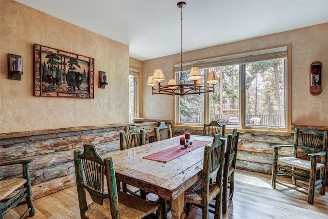 dining space with an inviting chandelier and wood finished floors