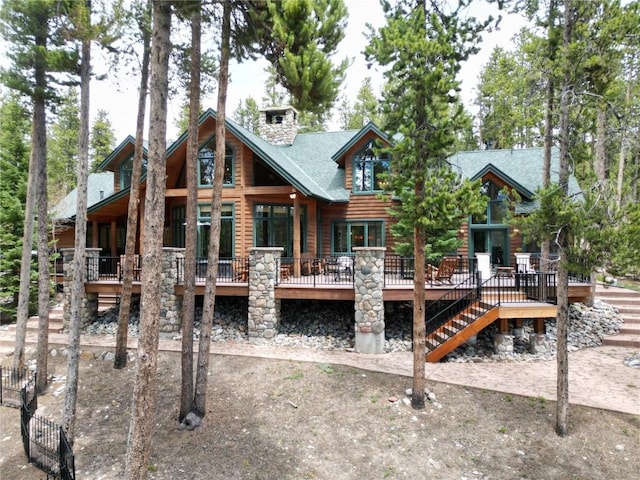 47 Forest Cir, Breckenridge, CO 80424 - back of house featuring a deck, a shingled roof, a chimney, log veneer siding, and stairway