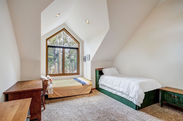 bedroom featuring carpet and vaulted ceiling