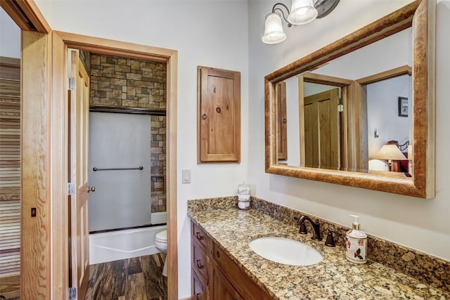 full bathroom featuring toilet, shower / tub combination, wood finished floors, and vanity