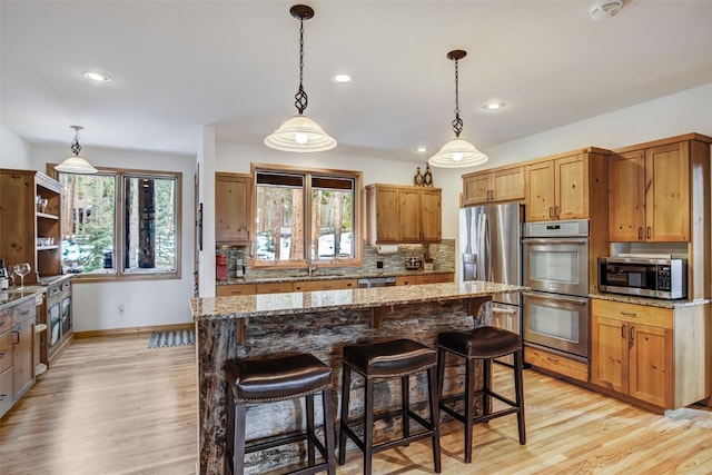 kitchen featuring stainless steel appliances, recessed lighting, and light wood-type flooring