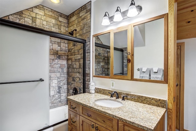 bathroom featuring vanity and enclosed tub / shower combo
