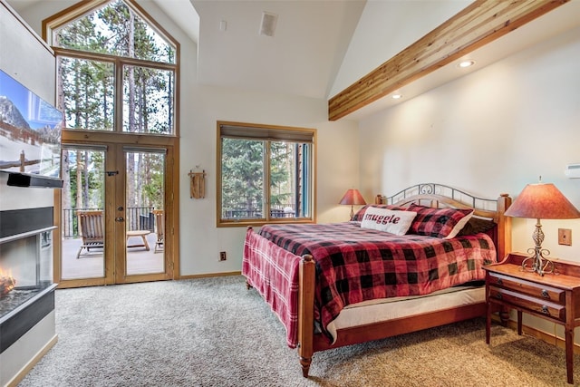 carpeted bedroom featuring high vaulted ceiling, access to exterior, baseboards, and multiple windows