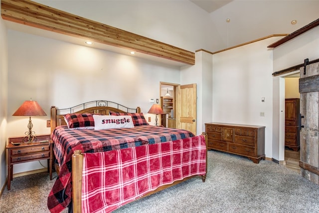 bedroom featuring carpet floors, baseboards, and a barn door
