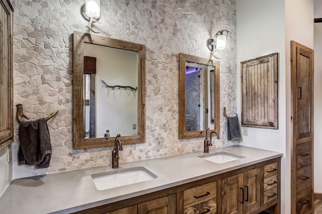 bathroom featuring a sink, tasteful backsplash, and double vanity