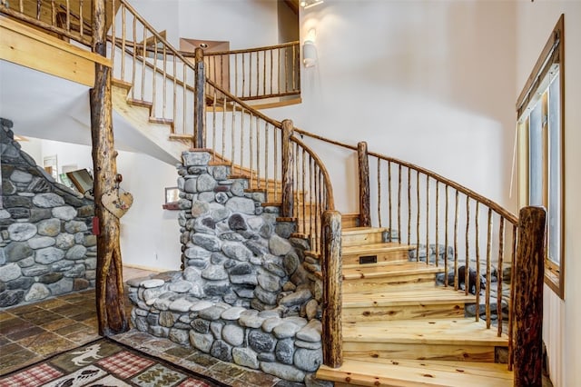 stairs featuring a high ceiling