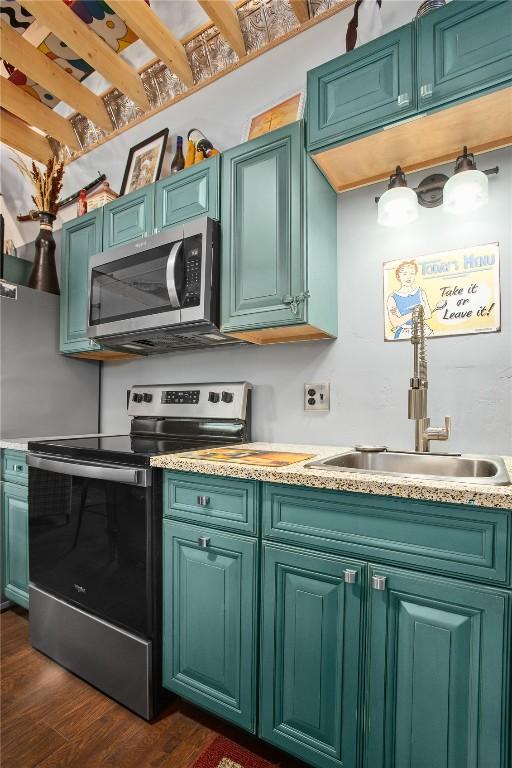 1295 Conestoga Cir, Steamboat Springs, CO 80487 - kitchen featuring stainless steel appliances, a sink, light countertops, and dark wood finished floors