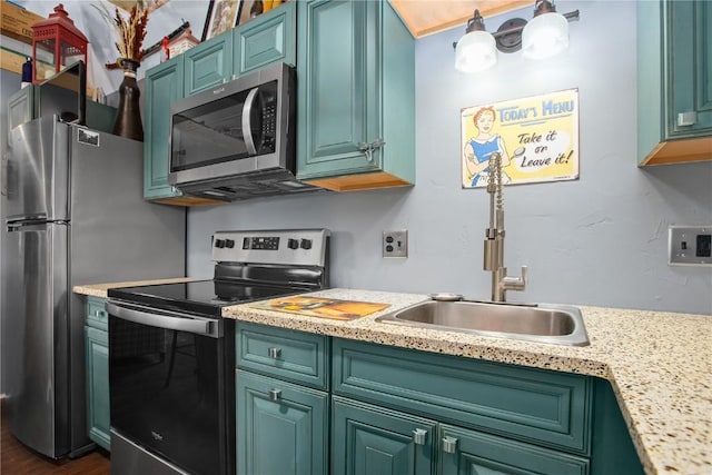 1295 Conestoga Cir, Steamboat Springs, CO 80487 - kitchen with stainless steel appliances, light countertops, a sink, and dark wood-style flooring