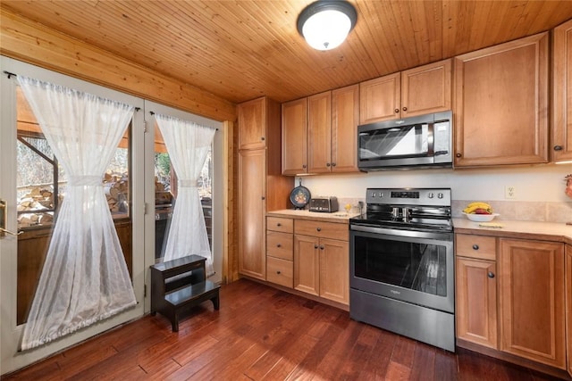 26635 Neptune Pl, Clark, CO 80428 - kitchen featuring appliances with stainless steel finishes, light countertops, dark wood-style floors, and wood ceiling