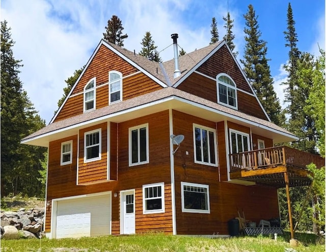 234 Peterson Dr, Alma, CO 80440 - back of property featuring an attached garage, a wooden deck, and roof with shingles