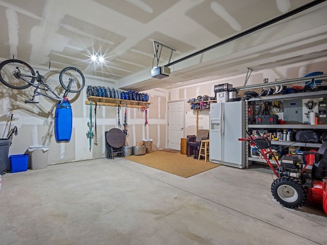 234 Peterson Dr, Alma, CO 80440 - garage with white fridge with ice dispenser and a garage door opener