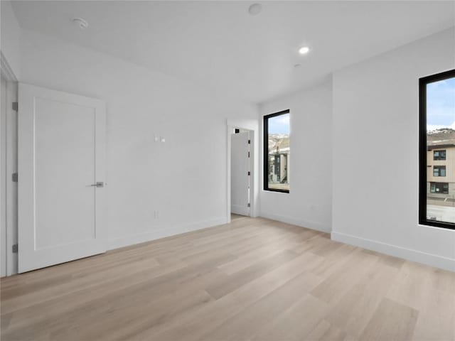 740 Blue River Pkwy Unit A21, Silverthorne, CO 80498 - spare room with baseboards, a healthy amount of sunlight, light wood-style floors, and recessed lighting