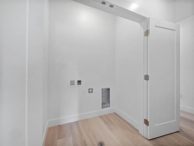 740 Blue River Pkwy Unit A21, Silverthorne, CO 80498 - clothes washing area featuring laundry area, wood finished floors, hookup for an electric dryer, hookup for a washing machine, and baseboards