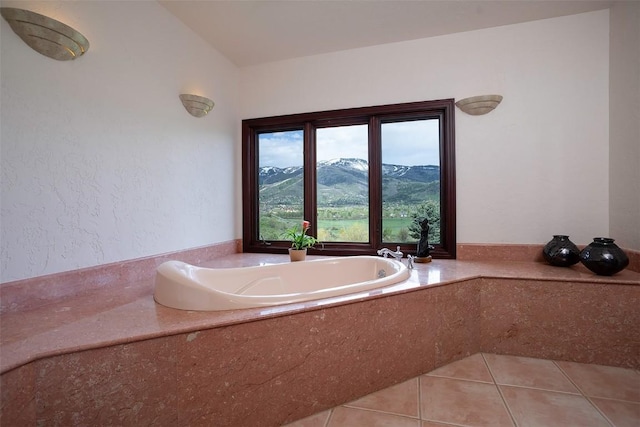 31695 Aspen Ridge Rd, Steamboat Springs, CO 80487 - bathroom featuring a garden tub, tile patterned flooring, and a mountain view