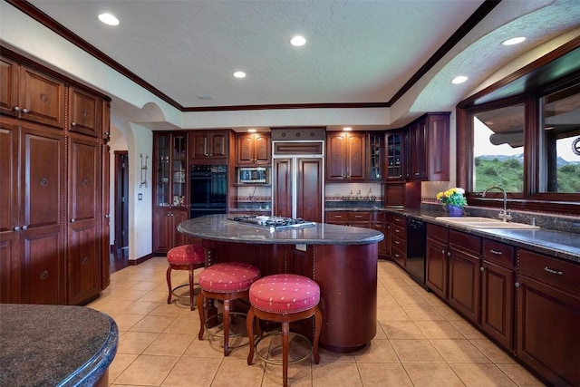 31695 Aspen Ridge Rd, Steamboat Springs, CO 80487 - kitchen with black appliances, light tile patterned floors, a center island, a breakfast bar area, and glass insert cabinets