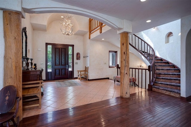 31695 Aspen Ridge Rd, Steamboat Springs, CO 80487 - tiled entryway with a chandelier, stairway, recessed lighting, arched walkways, and ornate columns