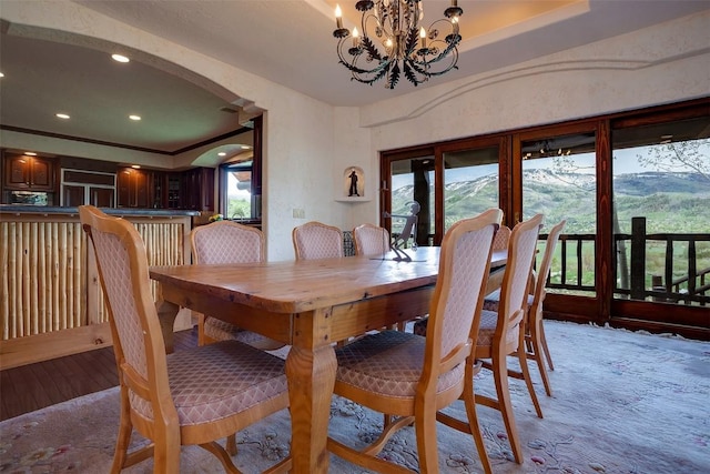 31695 Aspen Ridge Rd, Steamboat Springs, CO 80487 - dining space with arched walkways, plenty of natural light, recessed lighting, a chandelier, and light wood-style floors