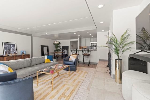 living area featuring recessed lighting and light tile patterned floors