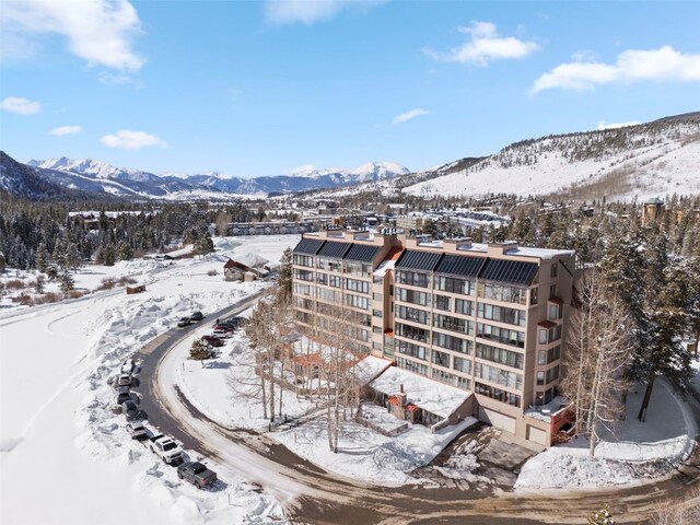 snowy aerial view featuring a mountain view