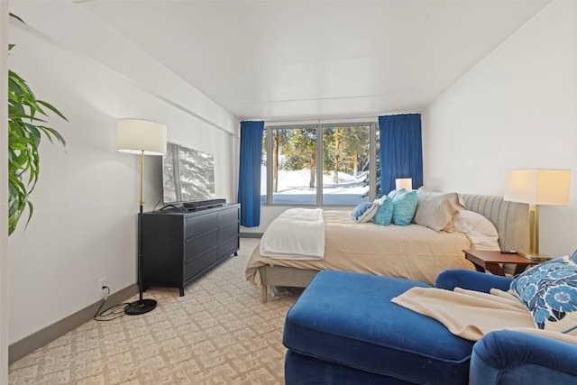 bedroom featuring baseboards and light carpet