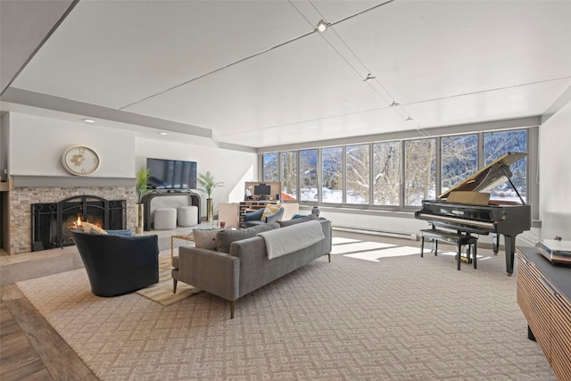 living room with a baseboard radiator and a warm lit fireplace