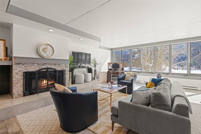 living room featuring recessed lighting, a baseboard radiator, a tiled fireplace, and a healthy amount of sunlight