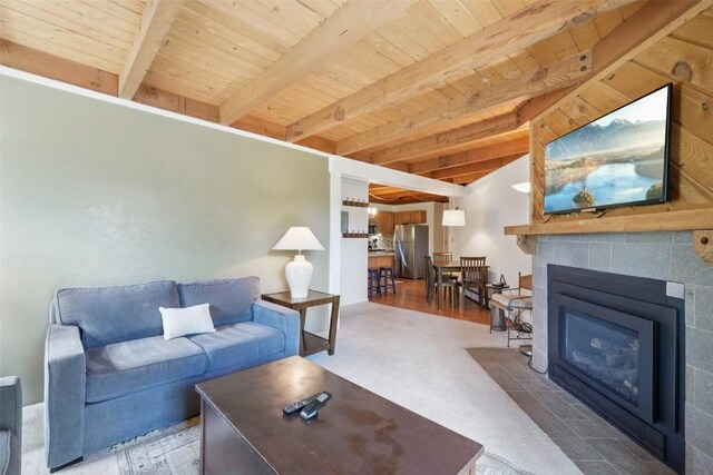 4200 Lodge Pole Cir Unit 205, Silverthorne, CO 80498 - living room with a wooden ceiling with exposed beams, a tiled fireplace, and carpet floors