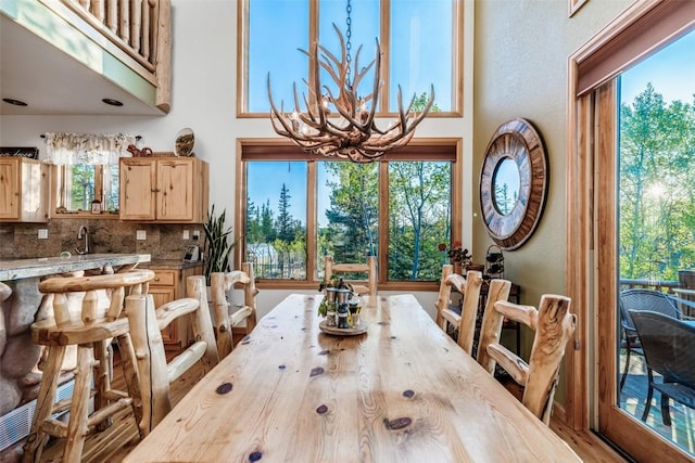 1996 Al Gulch Rd, Jefferson, CO 80456 - dining space with a towering ceiling, plenty of natural light, and a chandelier