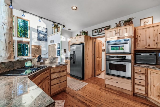 1996 Al Gulch Rd, Jefferson, CO 80456 - kitchen with appliances with stainless steel finishes, light brown cabinetry, light wood-style flooring, recessed lighting, and dark stone countertops