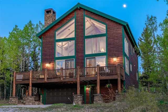 1996 Al Gulch Rd, Jefferson, CO 80456 - rear view of house featuring a wooden deck, an attached garage, and a chimney