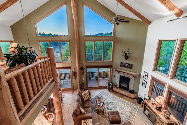 1996 Al Gulch Rd, Jefferson, CO 80456 - living room with high vaulted ceiling, beam ceiling, a premium fireplace, healthy amount of natural light, and a ceiling fan