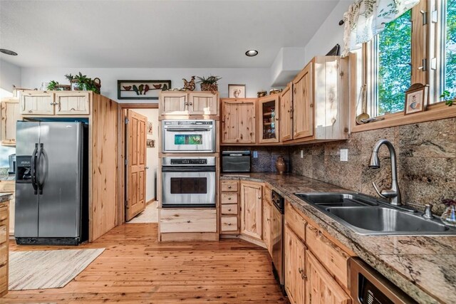 1996 Al Gulch Rd, Jefferson, CO 80456 - kitchen featuring stainless steel appliances, light wood-type flooring, light brown cabinets, backsplash, and recessed lighting