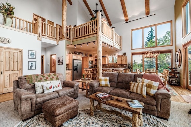 1996 Al Gulch Rd, Jefferson, CO 80456 - living area with high vaulted ceiling, light wood-style floors, a chandelier, and beam ceiling