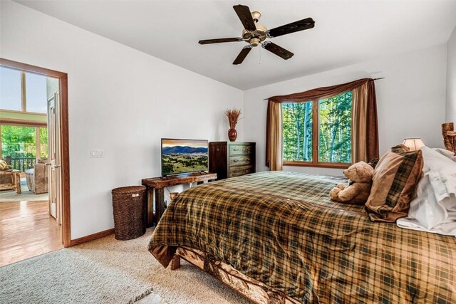 1996 Al Gulch Rd, Jefferson, CO 80456 - bedroom featuring multiple windows, light carpet, and ceiling fan