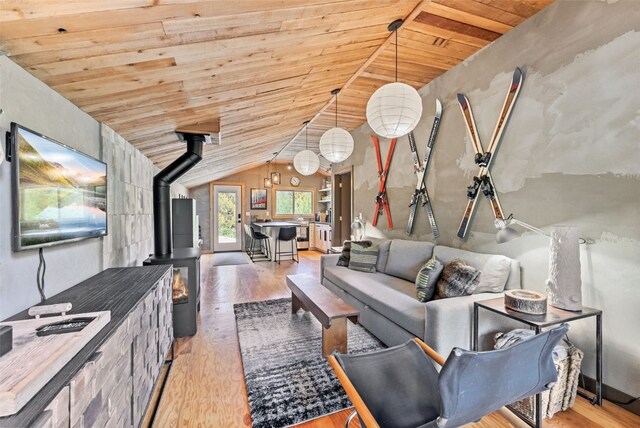 932 Peterson Dr, Alma, CO 80420 - living room featuring wooden ceiling, a wood stove, light wood-style floors, and vaulted ceiling