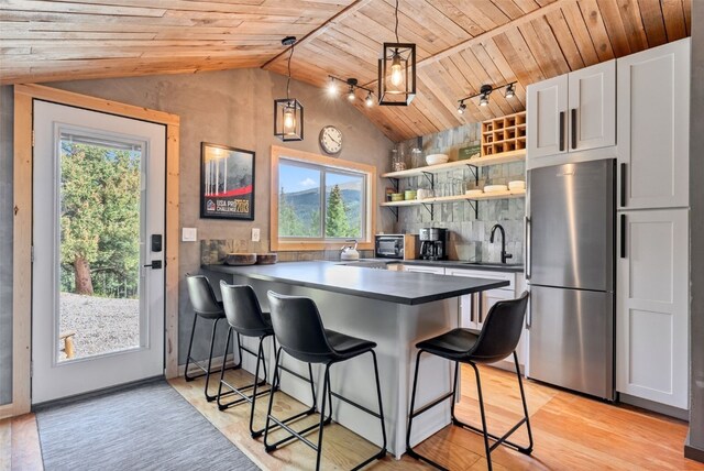 932 Peterson Dr, Alma, CO 80420 - kitchen featuring freestanding refrigerator, lofted ceiling, wood ceiling, a sink, and plenty of natural light