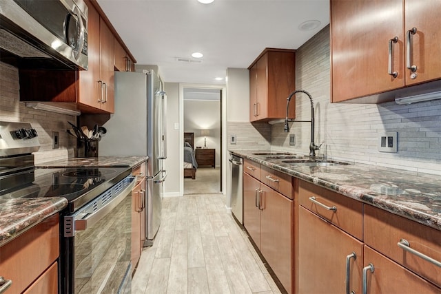 9359 State Highway 9 Unit G5, Breckenridge, CO 80424 - kitchen with stainless steel appliances, a sink, dark stone counters, backsplash, and recessed lighting