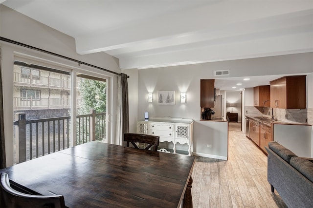 9359 State Highway 9 Unit G5, Breckenridge, CO 80424 - dining area with light wood-style flooring, beamed ceiling, and baseboards