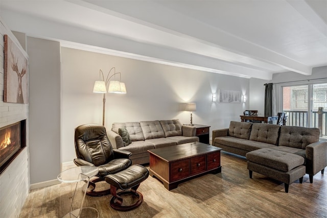 9359 State Highway 9 Unit G5, Breckenridge, CO 80424 - living area with wood finished floors, beamed ceiling, a fireplace, and baseboards