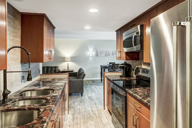 9359 State Highway 9 Unit G5, Breckenridge, CO 80424 - kitchen featuring appliances with stainless steel finishes, a sink, baseboards, light wood-style floors, and decorative backsplash