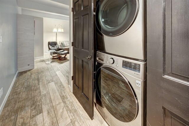 9359 State Highway 9 Unit G5, Breckenridge, CO 80424 - washroom featuring estacked washer and dryer, wood finished floors, and baseboards