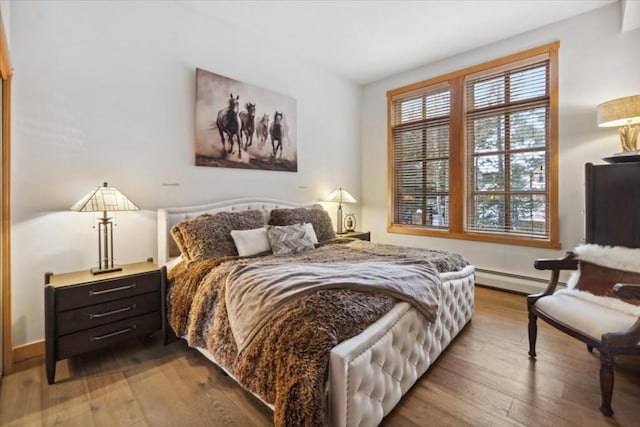 910 Copper Rd Unit 105, Frisco, CO 80443 - bedroom with a baseboard heating unit and wood finished floors