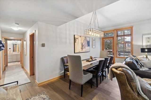 910 Copper Rd Unit 105, Frisco, CO 80443 - dining room featuring light wood-style flooring, baseboards, and a chandelier
