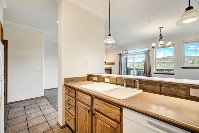 951 N Ten Mile Dr Unit C15, Frisco, CO 80443 - kitchen with dishwasher, light tile patterned floors, hanging light fixtures, crown molding, and a glass covered fireplace
