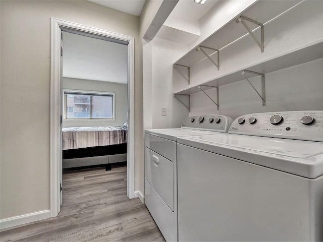1565 Shadow Run Frontage Unit 104, Steamboat Springs, CO 80487 - laundry area with baseboards, separate washer and dryer, and light wood finished floors