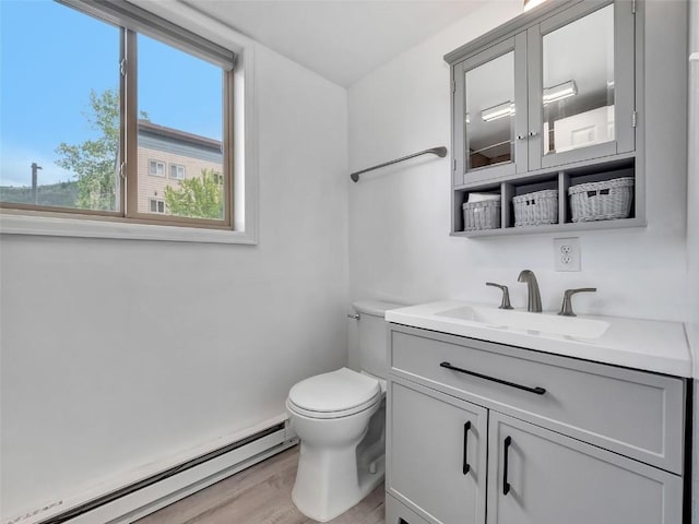 1565 Shadow Run Frontage Unit 104, Steamboat Springs, CO 80487 - bathroom with baseboard heating, toilet, vanity, and wood finished floors