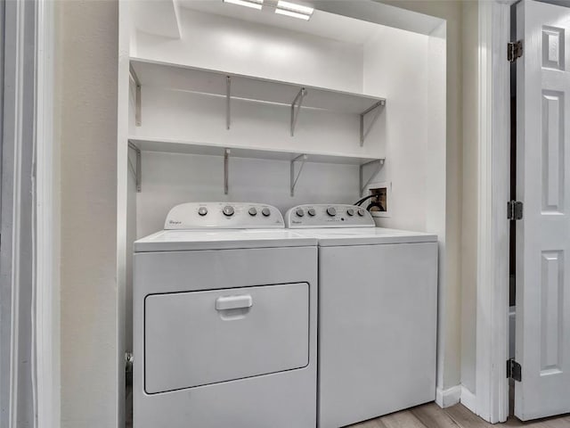 1565 Shadow Run Frontage Unit 104, Steamboat Springs, CO 80487 - laundry room with independent washer and dryer and light wood finished floors