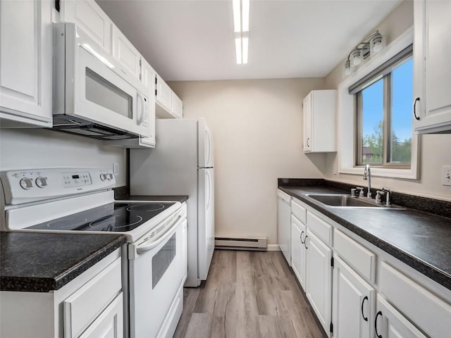 1565 Shadow Run Frontage Unit 104, Steamboat Springs, CO 80487 - kitchen featuring white appliances, a baseboard radiator, a sink, and dark countertops