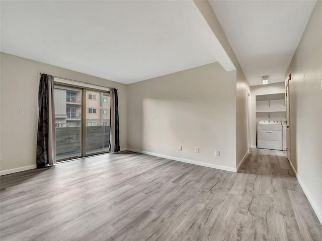 1565 Shadow Run Frontage Unit 104, Steamboat Springs, CO 80487 - empty room with washer and dryer, light wood-type flooring, and baseboards
