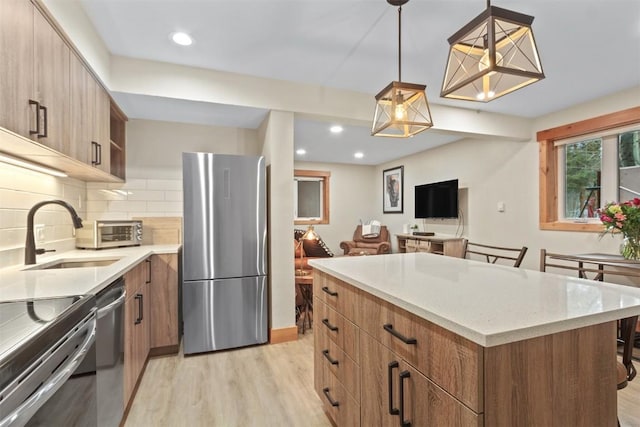 kitchen featuring light wood finished floors, modern cabinets, open shelves, and appliances with stainless steel finishes